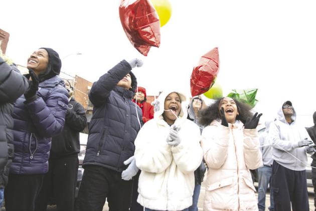 Spectators smile and cheer as they watch the annual Martin Luther King Jr. parade in Guthrie. Photo by Brent Fuchs