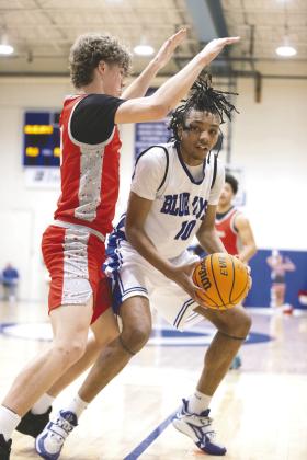 Guthrie’s Jahvari Harper looks to score against a Carl Albert defender during the Blue Jays’ 88-69 loss Feb. 6.