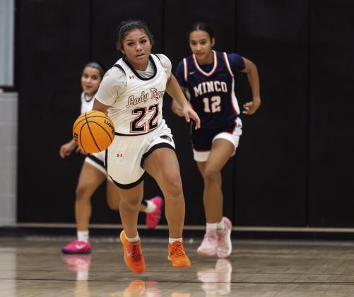 Lady Tigers Zori Wilson pushes the ball up the court during a girls basketball game as Minco defenders give chase. Photo Brent Fuchs