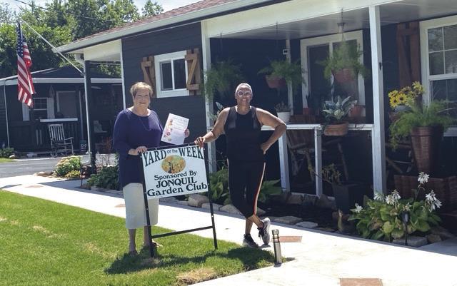 The Jonquil Garden Club has chosen to honor the Yard of the Week to Cheryl Craig-White, 1103 E Vilas. Pictured L to R: Pam Williams, representative of Jonquil Garden Club, and homeowner Cheryl Craig-White
