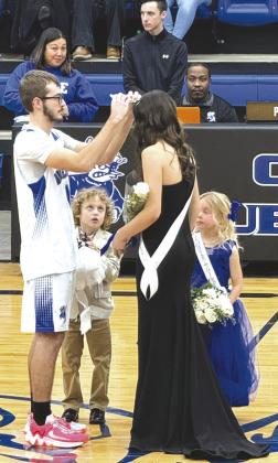 Queen is Crowned: King Alex Jennings crowns 2024 Basketball Queen Grace Balsiger as crown bearer Roman Walls and flower girl Olivia Ferrell look on. Photo by Wray Larman.