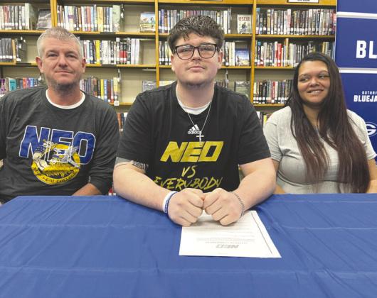 Guthrie High School senior Ethan Gilbert signs his letter of intent to play college football at NEO A&amp;M during a National Signing Day ceremony. Gilbert was a two-year starter on the Bluejays’ offensive line. Photo courtesy of Guthrie News Page.