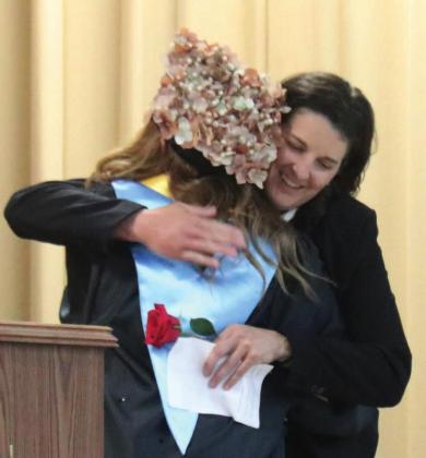 MO Principal Joline Oldebburg get roses from graduates