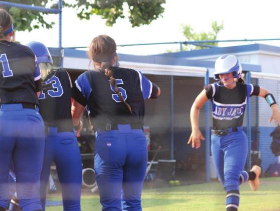 Elaina Clark greeted at home aftersecond inning home run
