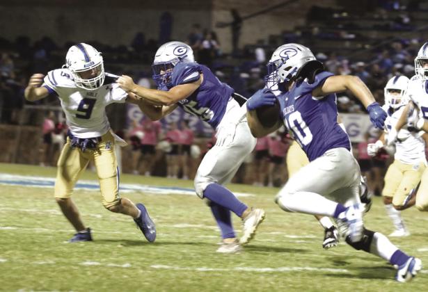 Blake Doles around the end as the tackle holds the defensive end.