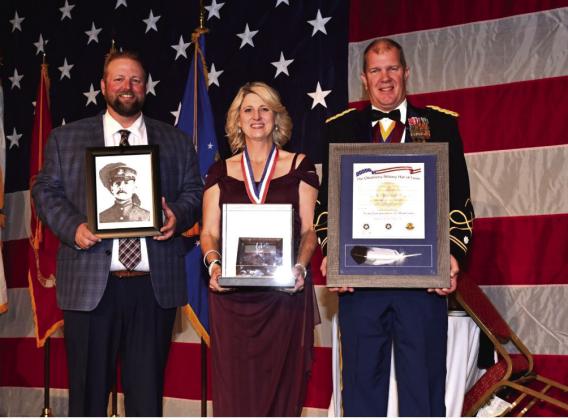 Accepting Oscar Upham’s induction into the Oklahoma Military Hall of Fame are (from left) Cody Hayes, Kathy Hayes and Lt. Col. T. Kyle Brede.