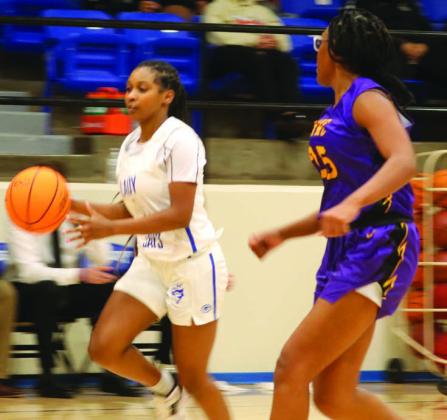 Alyana Wallace drives by Northwest Classen_sCerente Roberts on December13. Photos by Mike Monahan