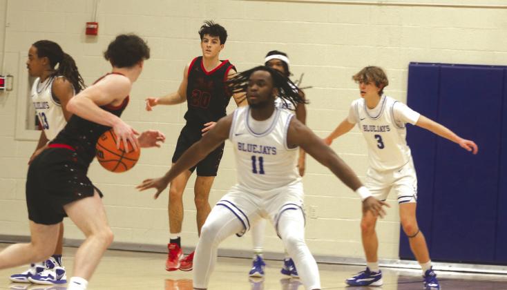 Guthrie Boys Basketball-Alex Clark plays defense against Elgin.