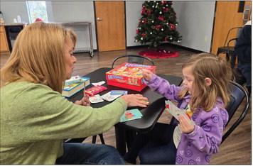 Volunteer Jennifer Husmann works with a sibling at Saturday’s event.