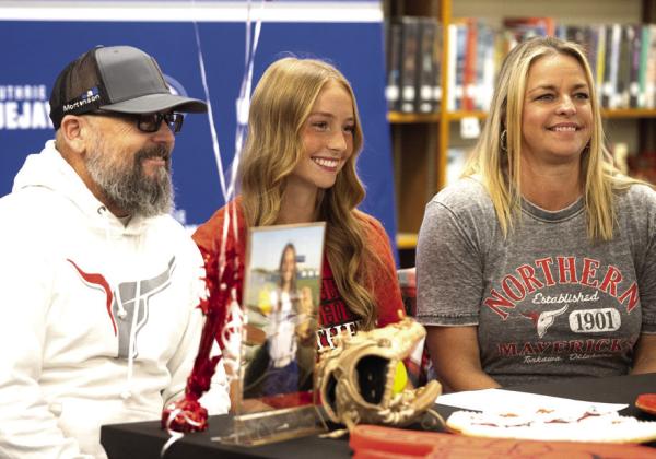 Codi with her parents at her signing. Photo by Brent Fuchs