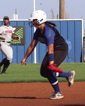 Lady Bluejays runner going to second base.