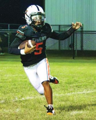 Jeremiah Rogers tries to avoid Mooreland tacklers during the Tigers’ 43-8 win on homecoming.