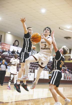 Parker Mitchell drives between Tonkawa defenders during Cashion’s 77-60 loss on senior night.