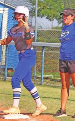 Haley Gallo at first base with Coach Kara Tarrant after base hit