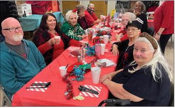 Attendees visit with one another while waiting to be served lunch at Highland Hall in Guthrie during the Logan County Aging Services Christmas dinner, where seniors gathered to enjoy a holiday meal and time with friends. Photo by Nikki Bos