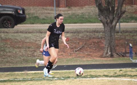 Guthrie’s Ally Carey dribbles up the field versus Christian Heritage, Thursday, March 13. Photo by George McCormick
