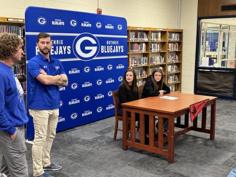 Peyton Read signing with NWOSU on Wednesday alongside head cross country coach Bryce Balenseifen. Taken by George McCormick.