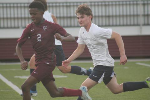 Edmond Memorial's Braylin Jones races an Edmond North defender to the ball, Wednesday, March 12. Taken by George McCormick.