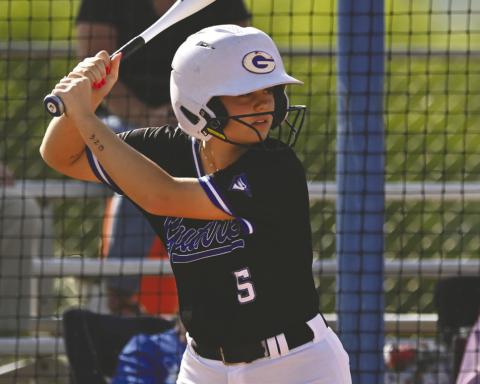 Guthrie’s Saylor Hamilton settles in at the plate, focusing on the pitch during Lady Jays action. Photo by Brett Tennyson