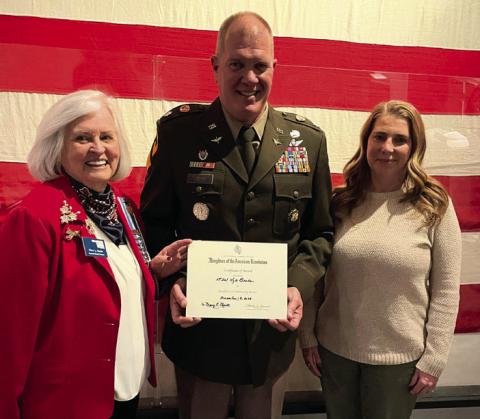 Dr. Mary Merritt, regent of the Samuel King Chapter NSDAR, presents Lt. Col. Kyle Brede with the NSDAR Community Service Award on Dec. 18, 2025. Photo, Nikki Bos