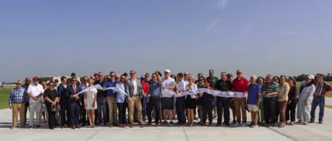 Airport officials, elected leaders and community members celebrate the completion of the Guthrie Edmond Regional Airport Taxiway Realignment Project during a ribbon cutting on the newly constructed taxiway June 30. Photo courtesy of the City of Guthrie.