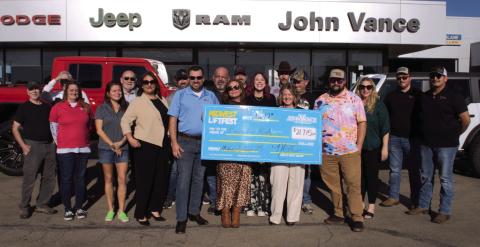 Megan Vance, Vance Auto Group staff, and LiftFest committee members, presents a check to CASA for Kids with funds raised at this year’s LiftFest in Guthrie, Okla.