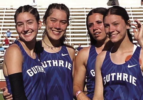 Guthrie High track athletes, from left, Cora Leach, Madi Brooks, Haley Gallo and Jackie Howell, celebrate after winning a Class 5A state championship in the 4x400-meter relay at the state track meet in Oklahoma City on May 17. Photo by Michael Kinney.