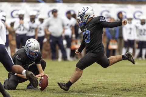 Guthrie kicker Ceasar Lopez attempts an extra point against Altus as Daelon Rice holds. The Bluejays came from behind to win.