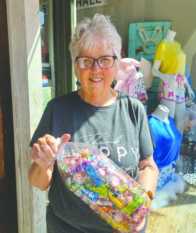 Jeanne Cook poses with candy jar from the Friends of the Library’s contest that will be held April 19-25 at the Guthrie Public Library.
