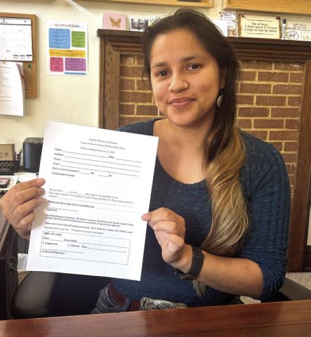 Pictured is Shu Fields, Office Administrator at the Guthrie First United Presbyterian Church, holding an application form for the Relief Grant.