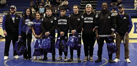 Pictured Above, Guthrie Wrestling Head Coach Jadon Davenport with seniors. Zhania Bryan, Khaleah Kirk, Braden Hall, Eli Kirk, Allyn Orndorff, Waylon Castle, Tikori (TK) Pierce, and Assistant Coach Jeromy Davenport. Photo by Mike Monahan