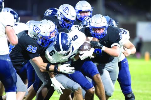 A host of Guthrie defenders take down an El Reno ball carrier during the Bluejays’ 42-0 win on Oct. 10 at Jelsma Stadium. The Guthrie defense limited the Indians to 50 yards of offense, including 15 yards through the air.