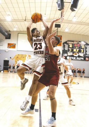 Crescent’s Chezdeon South scores goes up to score a basket during the 79-77 win over Watonga. Photo by Brent Fuchs