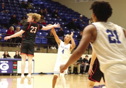 Jaylen Harper takes a shot with Crossings Christian player in face as Aiden Hardamen looks on.
