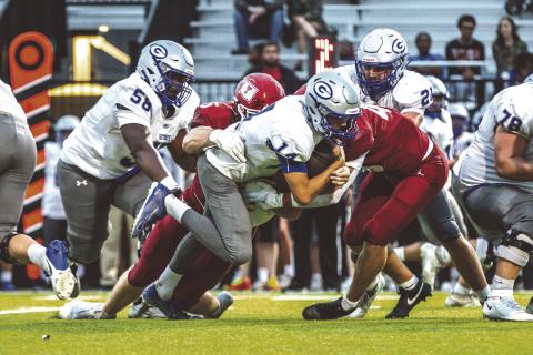 Guthrie quarterback Daelon Rice stretches for extra yardage as Tuttle defenders bring him to the ground. Guthrie players Sir’William Morgan(58) and Owen Wilder (78) are in on the play. Tuttle won 38-13.