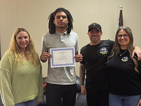 Pictured with Aiden is Rotarian Brittany Timmons and Jimmy and Kiesha Johnson with Chef Jimmy’s Baked Goods.