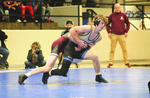 Guthrie's Aydin Smith fights with Perry's Carson Avery in a dual between the two schools, Thursday, Dec. 5.