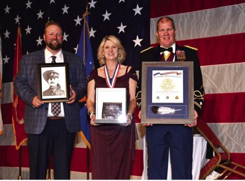 Accepting Oscar Upham’s induction into the Oklahoma Military Hall of Fame are (from left) Cody Hayes, Kathy Hayes and Lt. Col. T. Kyle Brede.