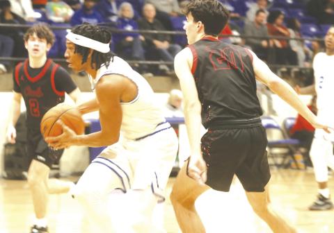 Nate Benford drives to the basket against Elgin.