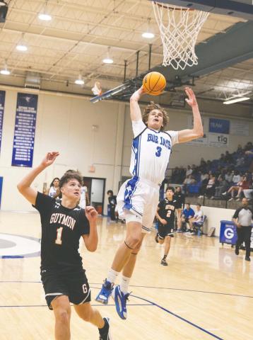 Guthrie’s Kolson Smedley goes up for one of his eight slam dunks against Midwest City on Jan. 16. Photo by Brent Fuchs.