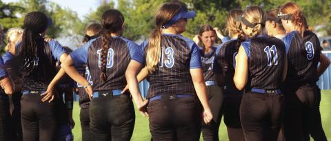 Lady Bluejays get words of wisdom from Coach Kara Tarrant after win.