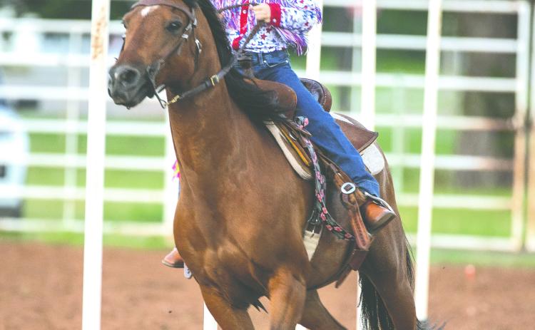 Margaret Boulter of Minco competes in the pole bending event during the Guthrie Youth Rodeo on Saturday at the Logan County Fairgrounds.
