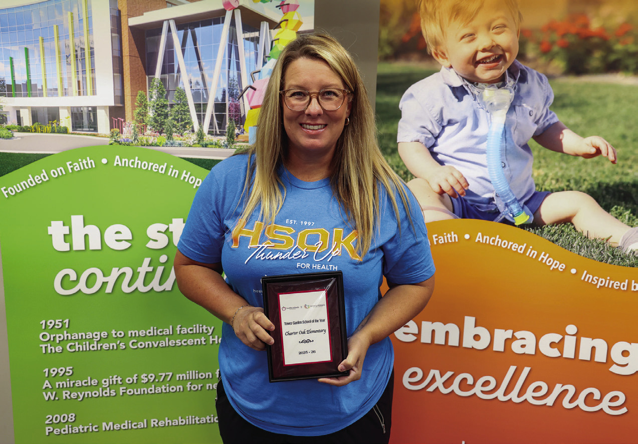 Aaron Harbin, P.E. teacher at Charter Oak Elementary accepted the Tower Garden School of the Year on July 29.