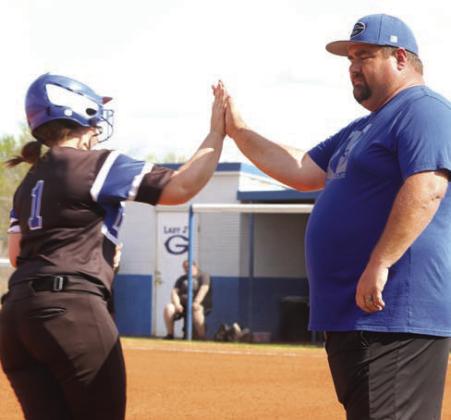 Ashlee Eichler gets the high five from Coach Booker Blakley after first inning home run.
