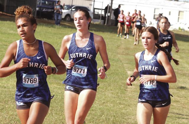 Guthrie XC Jaidence Foster (9769) Raley Hooper (9771) and Peyton Read (9775) run together as they head for finish line.