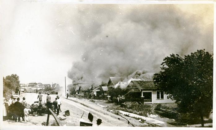 Smoke rises from damaged properties after the Tulsa Race Massacre in Tulsa, Oklahoma June 1921. (Picture courtesy of Oklahoma Historical Society via Getty Images)
