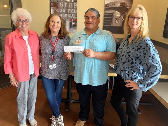 "Guthrie Lions Club members Sylvia Ochs (left) and LeAnn Ramsey (right) present a "promissory note" for $450 to Guthrie Hope House representatives; Natalie Cunningham (center), Women's Facility Director and Frankie Garcia (center), Program Administrator."