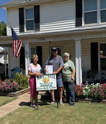 Jonquil Garden Club is pleased to announce their Yard of the week to the Poupards at 1706 West Cleveland. Pictured is Brenda Nivens, Jonquil Garden Club member and Gary and Ramona Poupard.