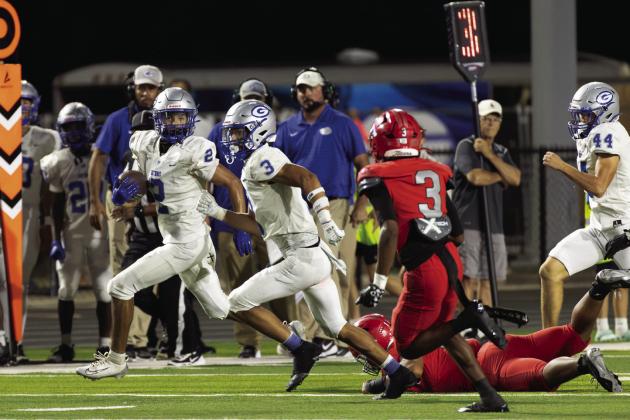 Guthrie’s Skylor Scamman, left, carries the ball with teammate Codie Carlock running alongside during Guthrie’s game at Carl Albert in Midwest City. Photo by Brent Fuchs.