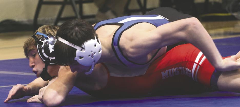 GHS Dax Lopez works on his Mustang opponent on way to a 4-0 win.